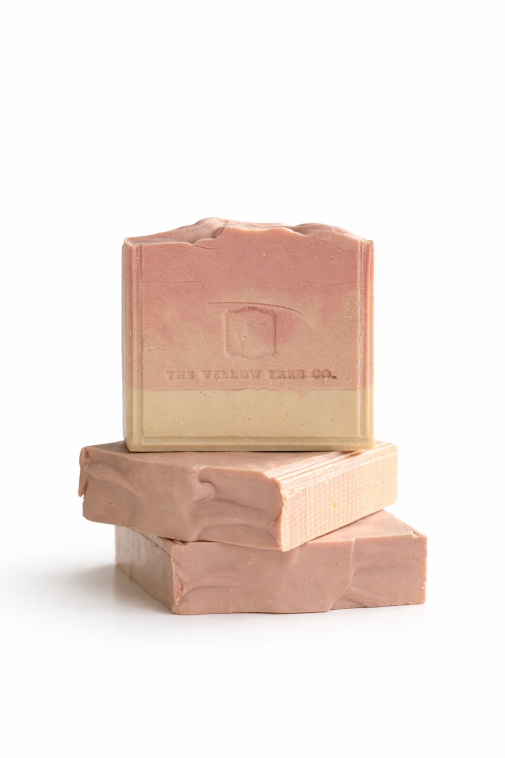 Three stacked soap bars with a visible brand logo on a white background