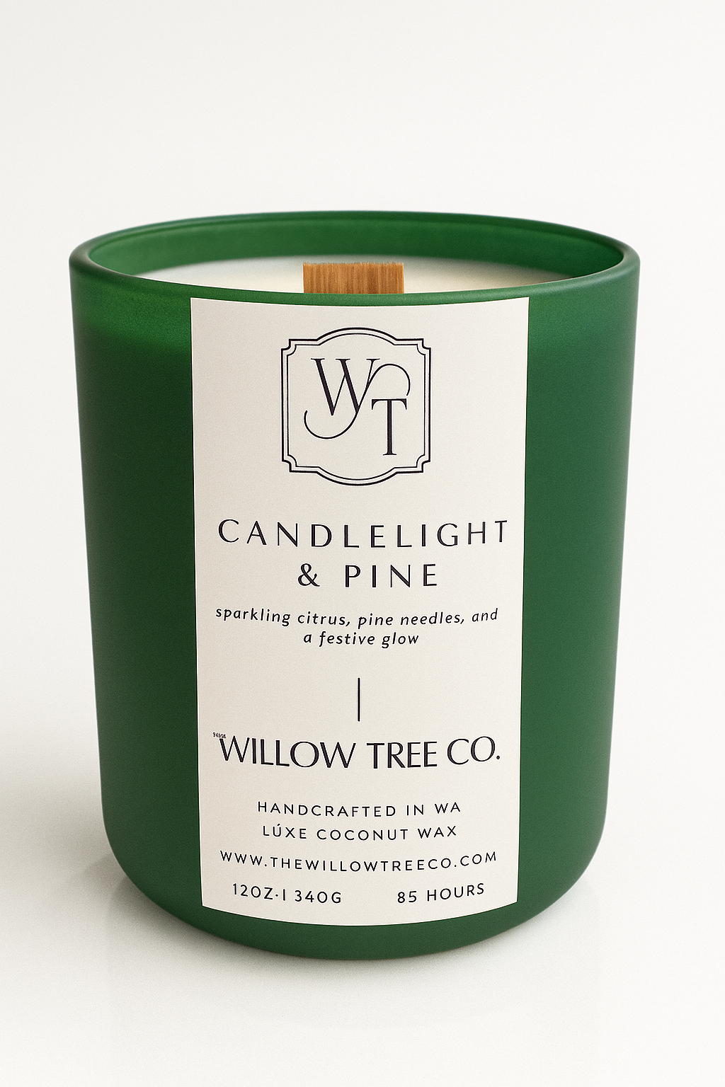 Green candle with a white label from Willow Tree Co. on a white background
