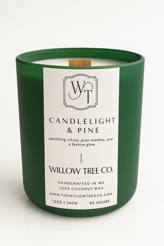 Green candle with a white label from Willow Tree Co. on a white background