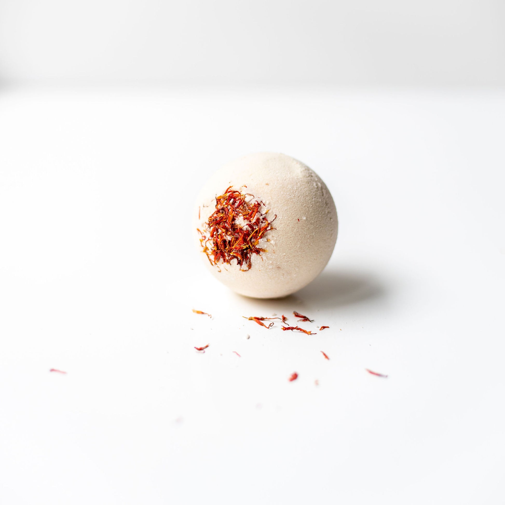 Bath bomb with saffron on a white background