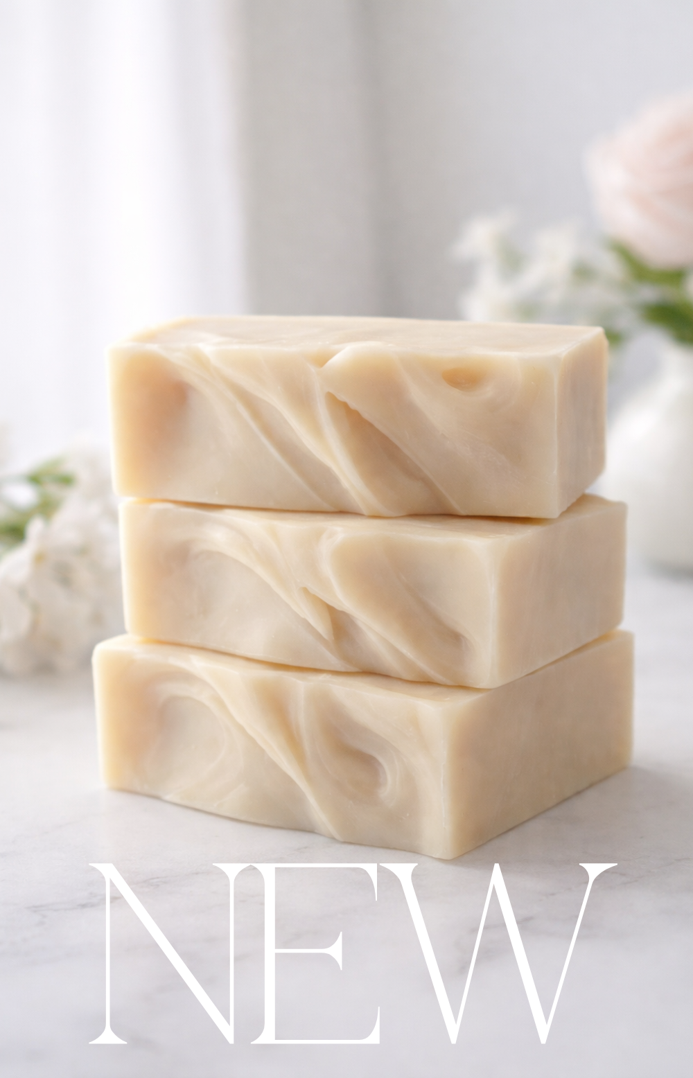 Three bars of soap stacked on a light surface with 'NEW' text overlay.