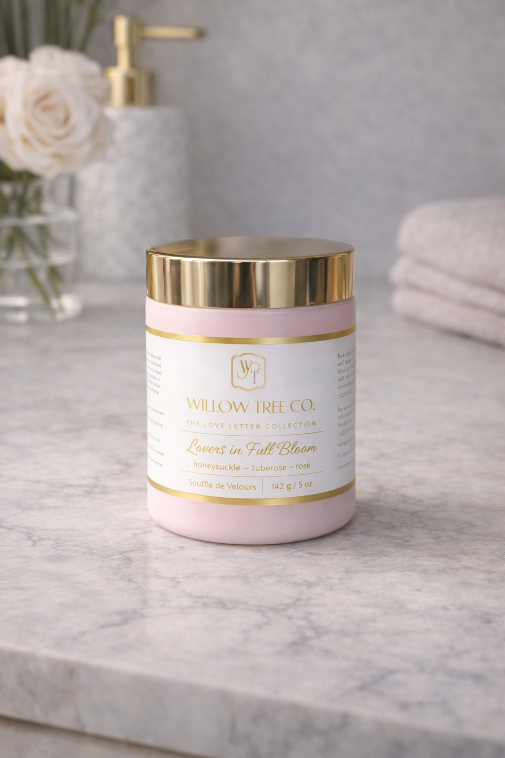 Pink and gold container with 'Willow Tree Co.' branding on a marble surface.