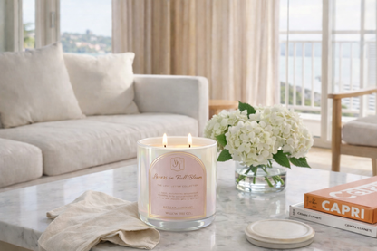 Candle with a pink label on a coffee table in a living room setting