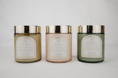 Three body cream jars with metallic lids on a light gray background