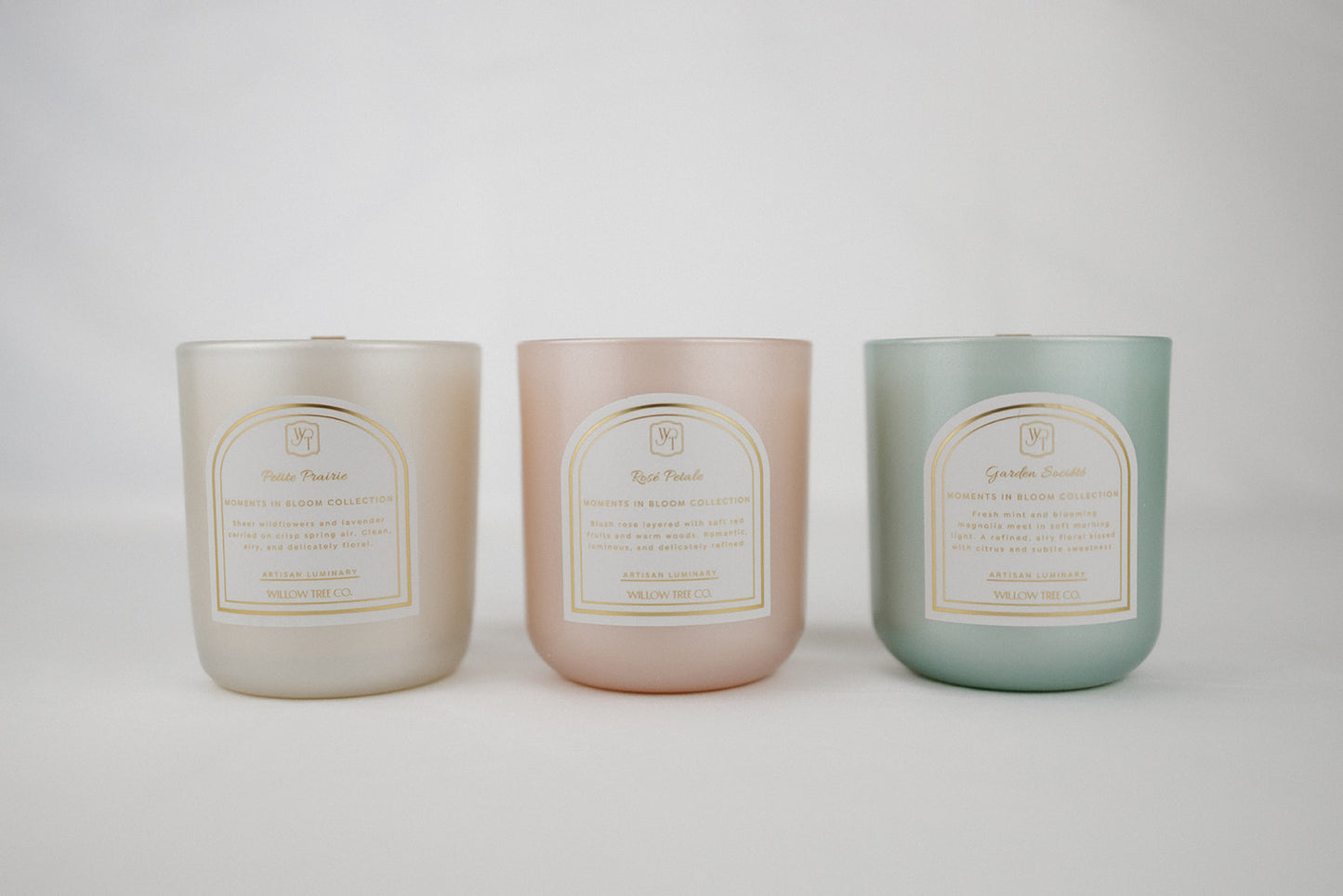 Three candles in pastel colors with labels on a white background