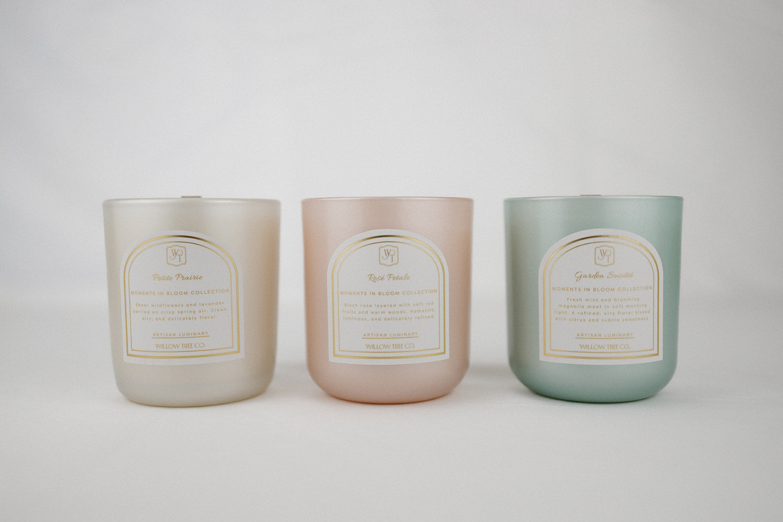 Three candles in pastel colors with labels on a white background