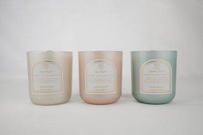 Three candles in pastel colors with labels on a white background