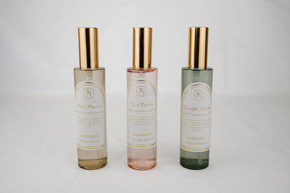 Three glass bottles with gold caps on a light gray background