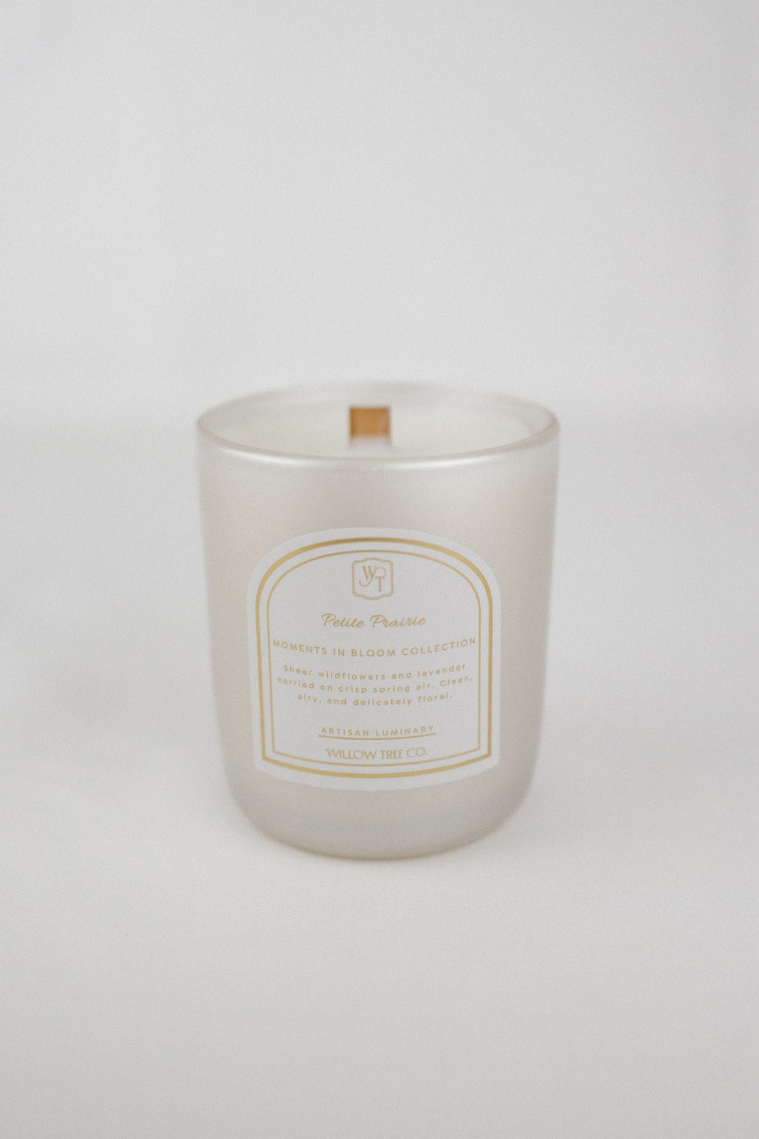 Pearl white candle with a label on a white background