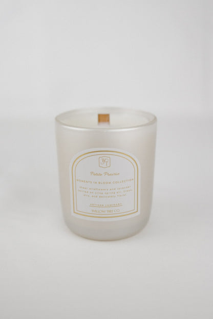 Pearl white candle with a label on a white background