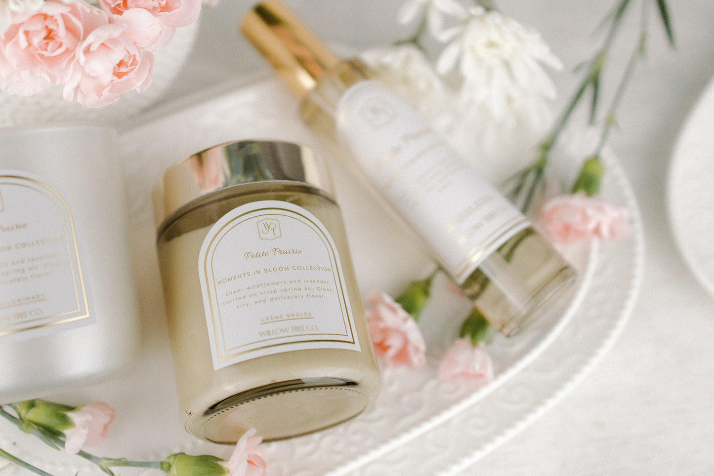 Cosmetic products with floral elements on a white surface