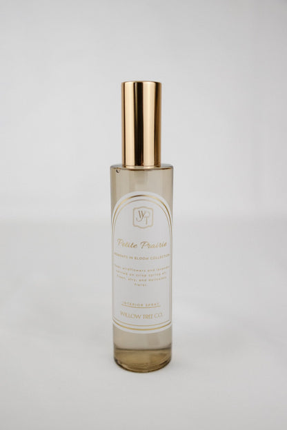 Gold interior spray with gold cap on a light gray background