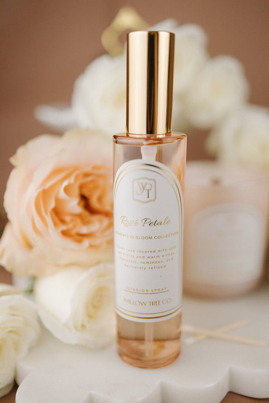 Perfume bottle with gold cap on a floral background