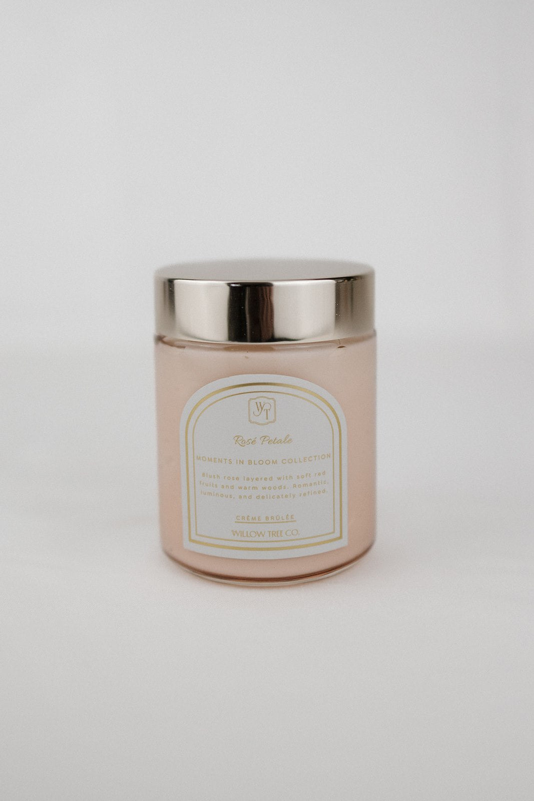 Pink body cream jar with a gold lid on a light gray background