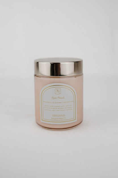 Pink body cream jar with a gold lid on a light gray background