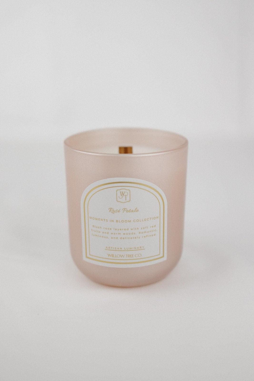 Pearl blush pink candle with a label on a white background