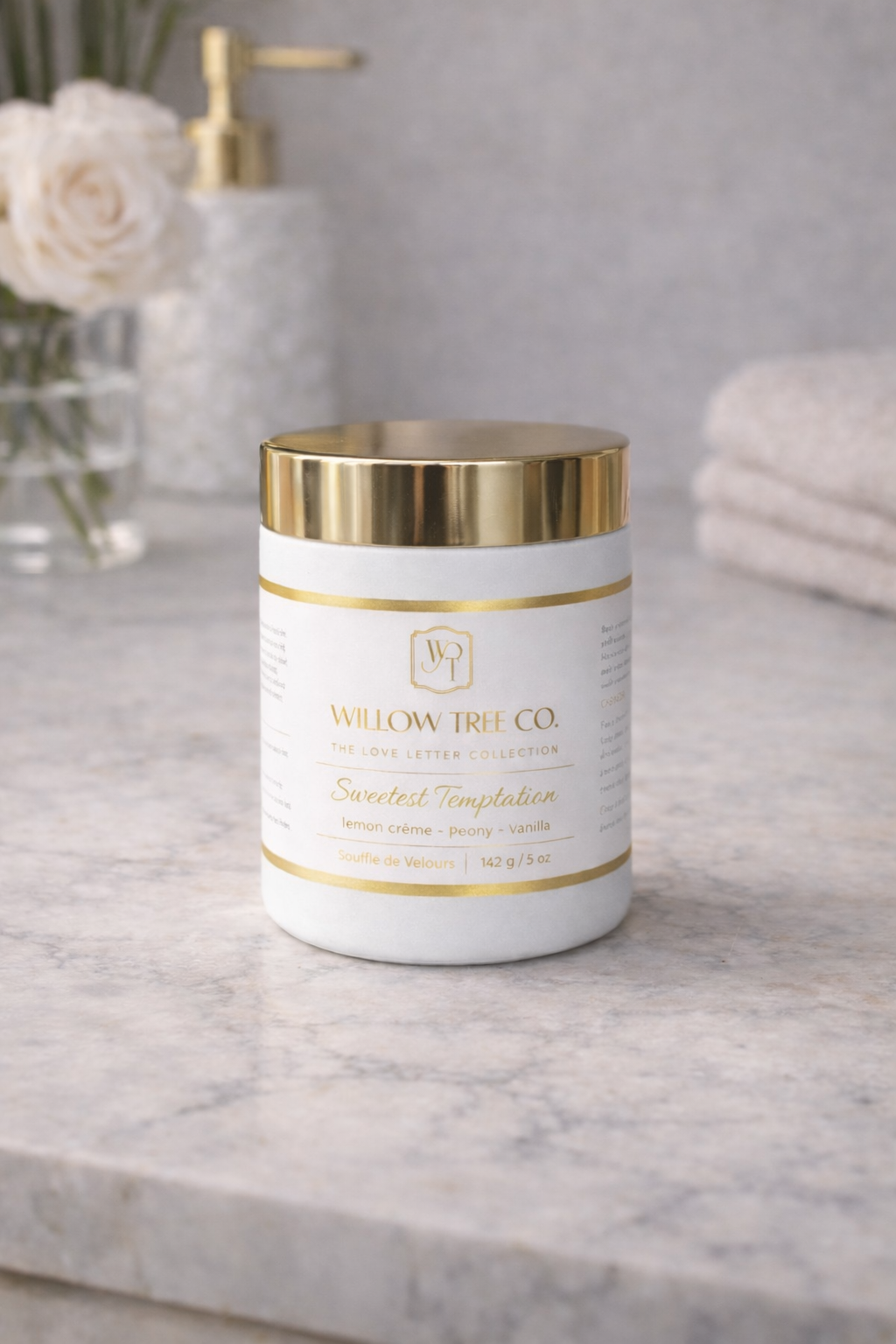 Body butter jar with gold lid and 'Willow Tree Co.' label on a marble surface.